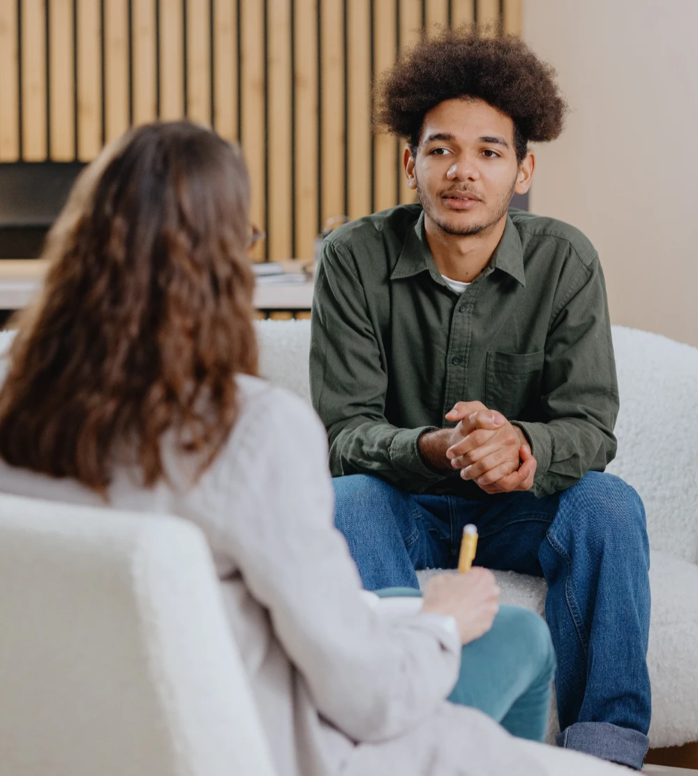 A young man sitting across from his therapist